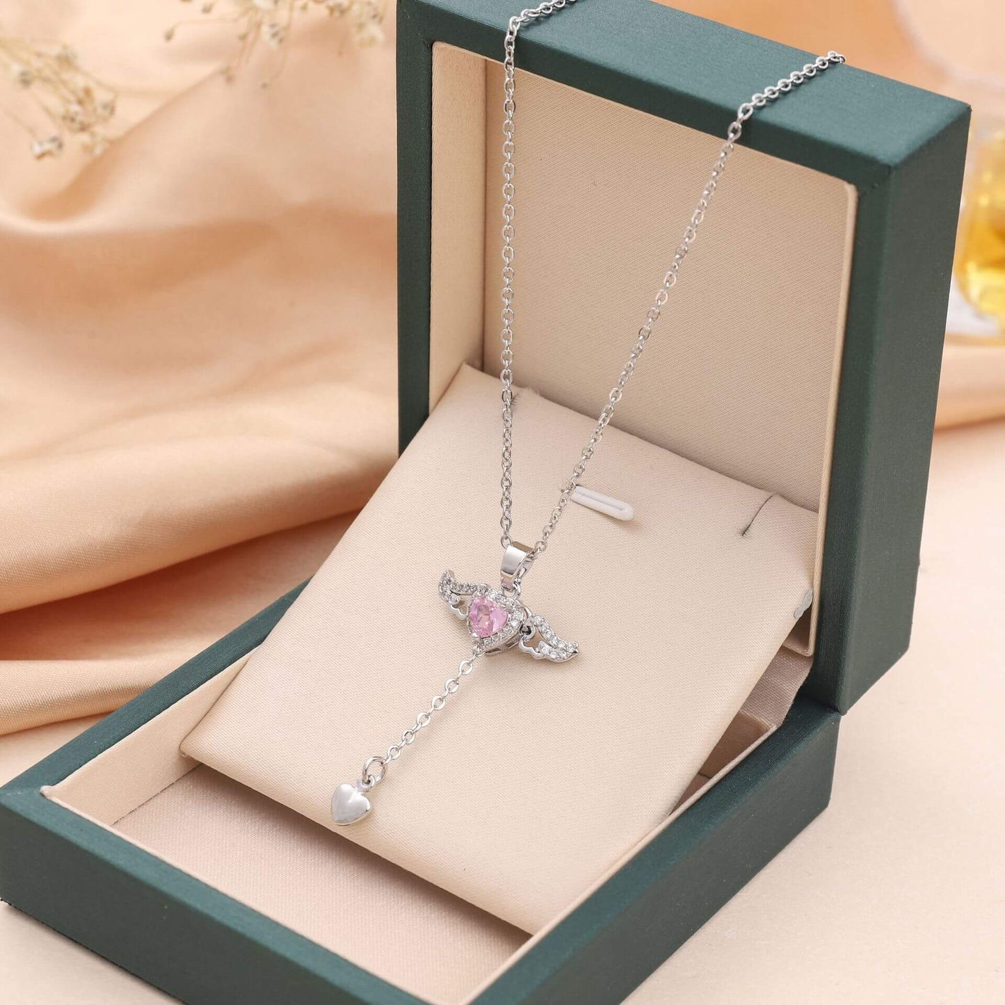 Moving Cupid Heart Angel Wings Tassel Necklace With Crystal displayed in an elegant gift box.
