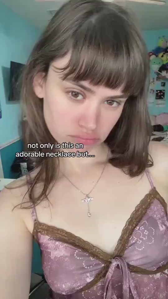 Moving Cupid Heart Angel Wings Tassel Necklace With Crystal worn by a model, showcasing its delicate design and shine.