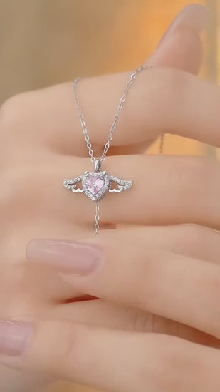 Moving Cupid Heart Angel Wings Tassel Necklace With Crystal on hand, showcasing exquisite design and zircon crystal sparkle.
